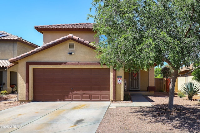 mediterranean / spanish-style home with a garage, concrete driveway, and stucco siding