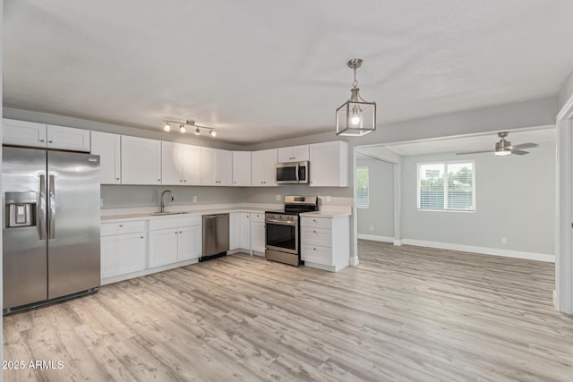 13202 N 40th Pl, Phoenix, AZ 85032 - kitchen featuring appliances with stainless steel finishes, a sink, light countertops, light wood finished floors, and baseboards
