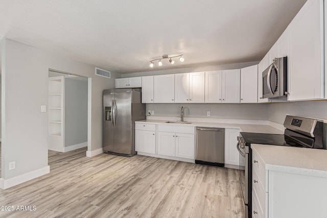 13202 N 40th Pl, Phoenix, AZ 85032 - kitchen featuring stainless steel appliances, light wood-style flooring, a sink, and white cabinetry