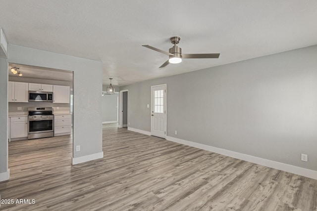 13202 N 40th Pl, Phoenix, AZ 85032 - unfurnished living room with baseboards, light wood-type flooring, and ceiling fan