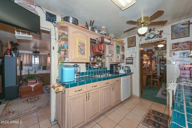 kitchen with sink, white appliances, tile countertops, light tile patterned floors, and ceiling fan