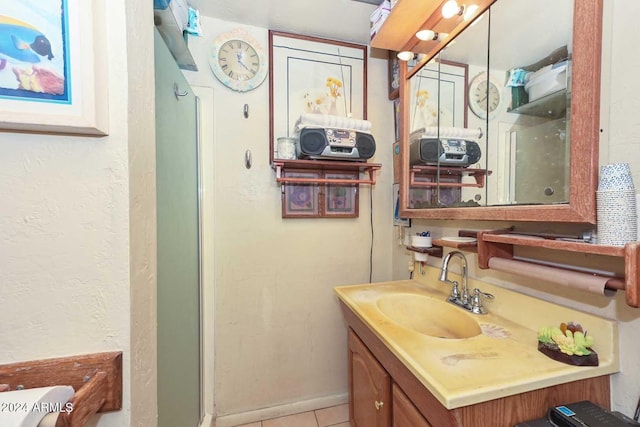 bathroom with tile patterned flooring and vanity