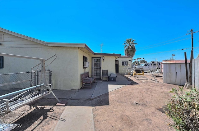 exterior space featuring a patio and a storage shed