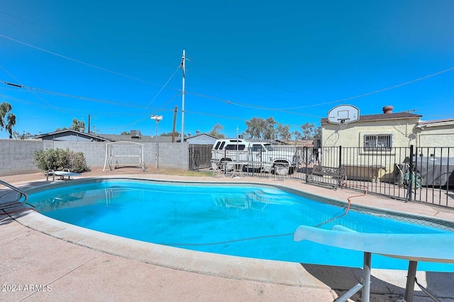 view of swimming pool with a patio