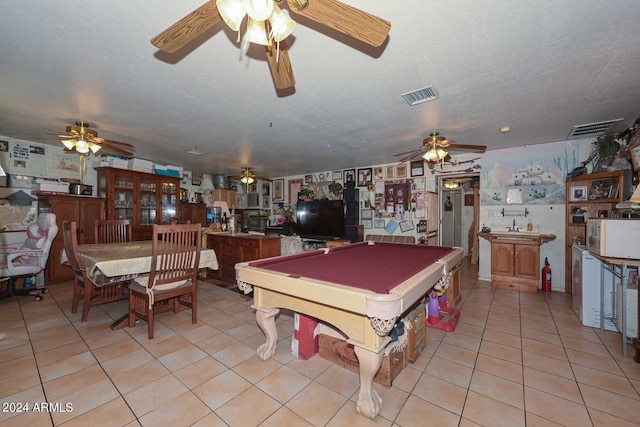 playroom with a textured ceiling, light tile patterned floors, ceiling fan, and billiards