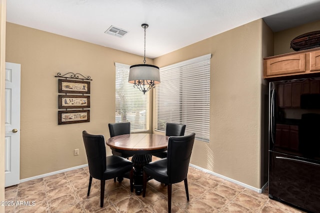 dining room featuring a notable chandelier