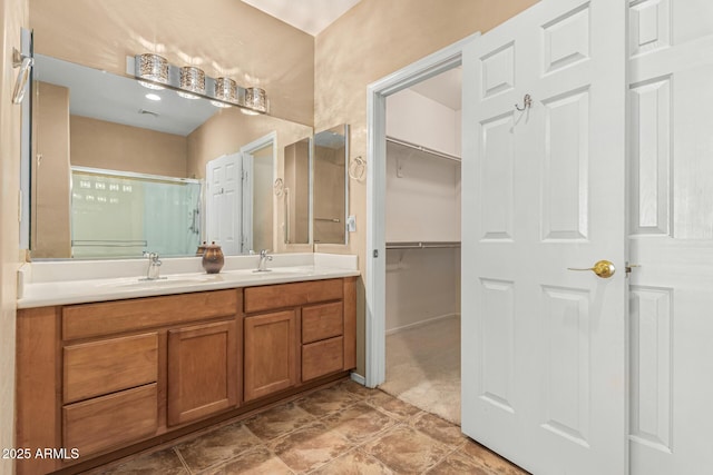 bathroom featuring an enclosed shower and vanity