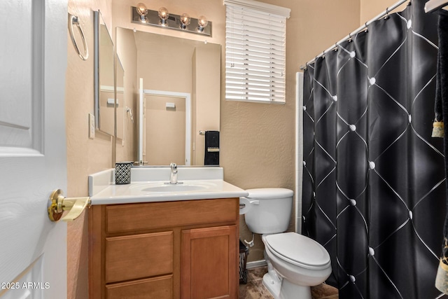 bathroom with vanity, curtained shower, and toilet