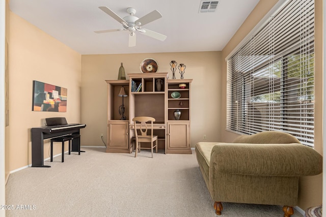 living area featuring ceiling fan and light carpet