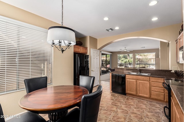 kitchen featuring pendant lighting, ceiling fan, sink, and black appliances