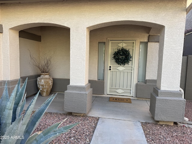 doorway to property with stucco siding