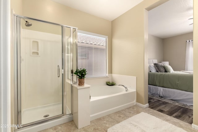 ensuite bathroom featuring a shower stall and a bath