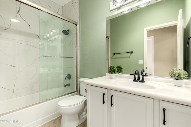 bathroom with toilet, vanity, and enclosed tub / shower combo