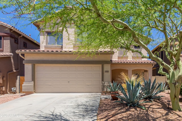 mediterranean / spanish-style house featuring concrete driveway, stucco siding, and a tile roof