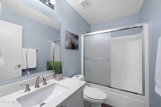 full bathroom featuring toilet, shower / bath combination with glass door, vanity, and visible vents