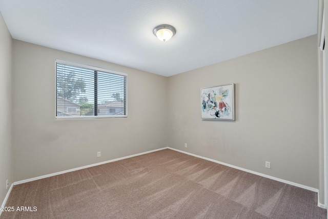 spare room with carpet flooring and baseboards