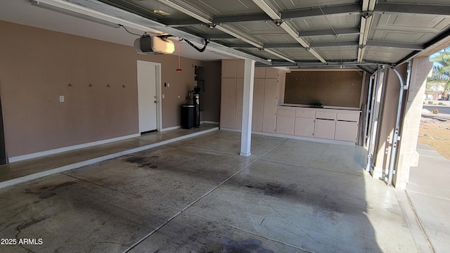 garage featuring baseboards and a garage door opener