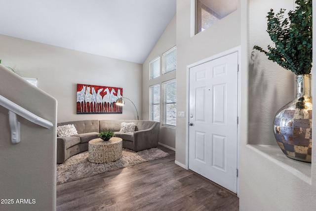 entrance foyer with high vaulted ceiling and wood finished floors