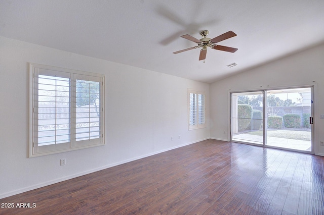 spare room with ceiling fan, dark wood-type flooring, and vaulted ceiling