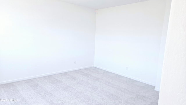 unfurnished room with light colored carpet