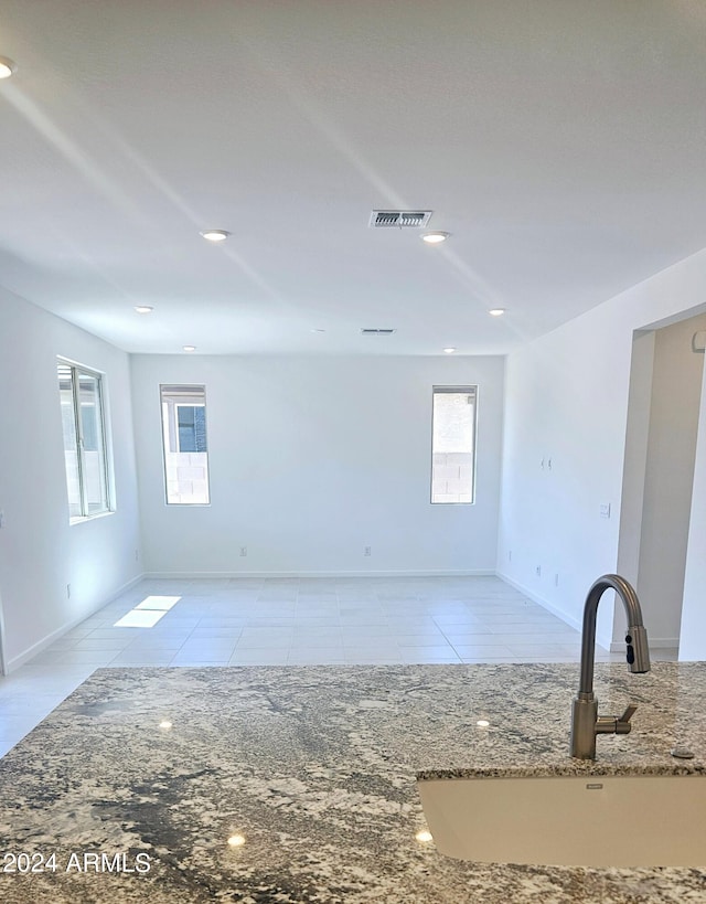 tiled empty room featuring sink