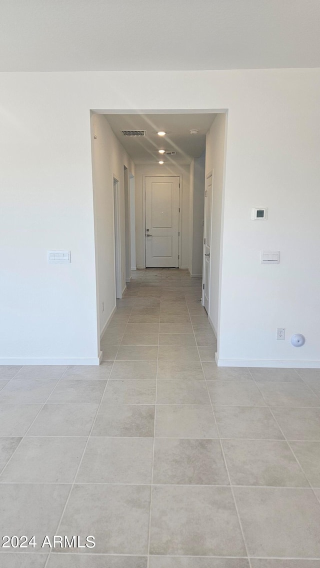 corridor featuring light tile patterned floors