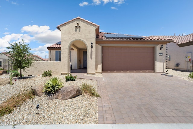 26824 W Ponderosa Ln, Buckeye, AZ 85396 - mediterranean / spanish-style house featuring stucco siding, a tile roof, roof mounted solar panels, a garage, and decorative driveway