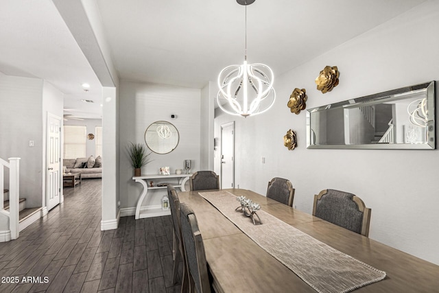 dining space featuring dark wood-type flooring and a chandelier