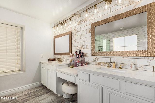 bathroom featuring hardwood / wood-style flooring, vanity, and tasteful backsplash