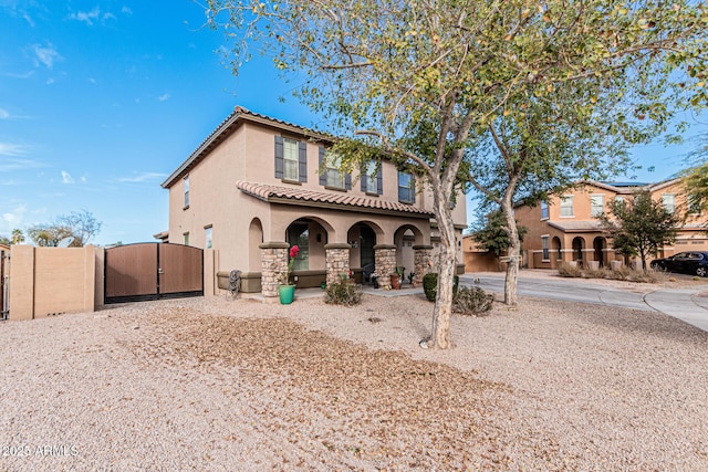 mediterranean / spanish home featuring covered porch