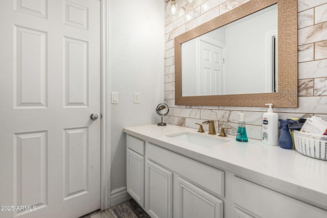 bathroom with tasteful backsplash and vanity