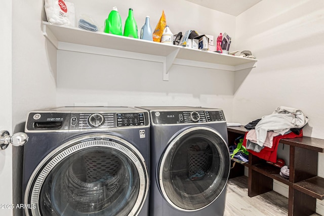 laundry area featuring washer and clothes dryer and light wood-type flooring