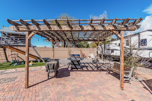 view of patio / terrace with a pergola and a playground