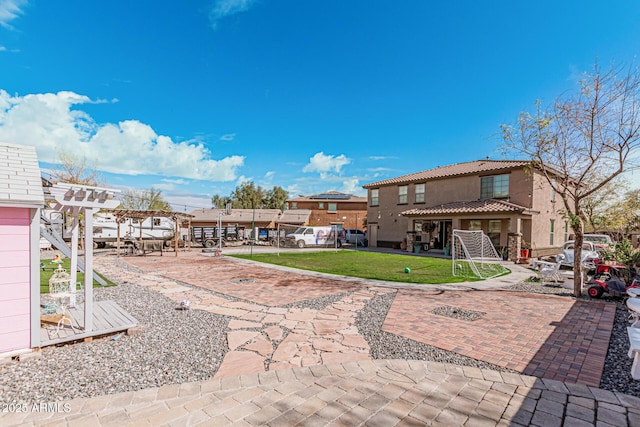 back of house with a patio area and a lawn