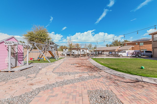 exterior space with a playground, a lawn, and a pergola