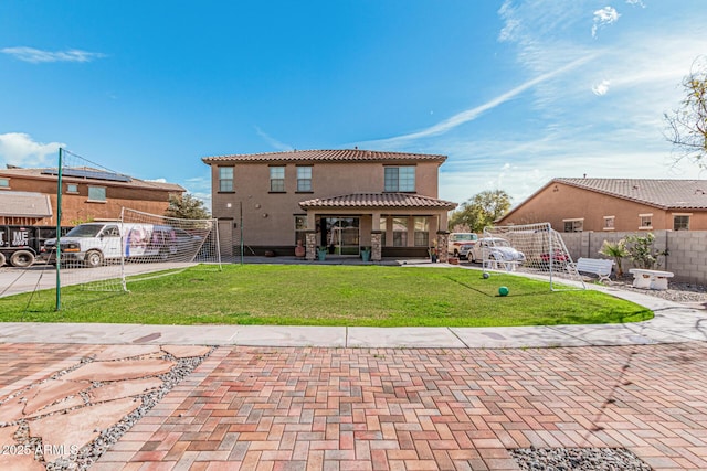 back of property featuring a lawn