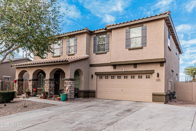 mediterranean / spanish house featuring a garage