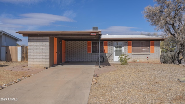 ranch-style house with a carport and cooling unit