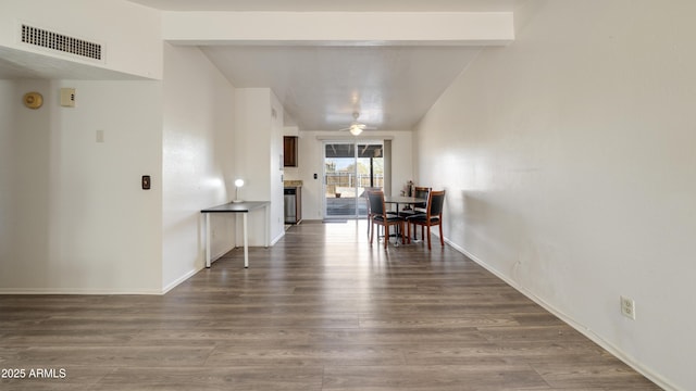 dining room with hardwood / wood-style floors, vaulted ceiling with beams, and ceiling fan