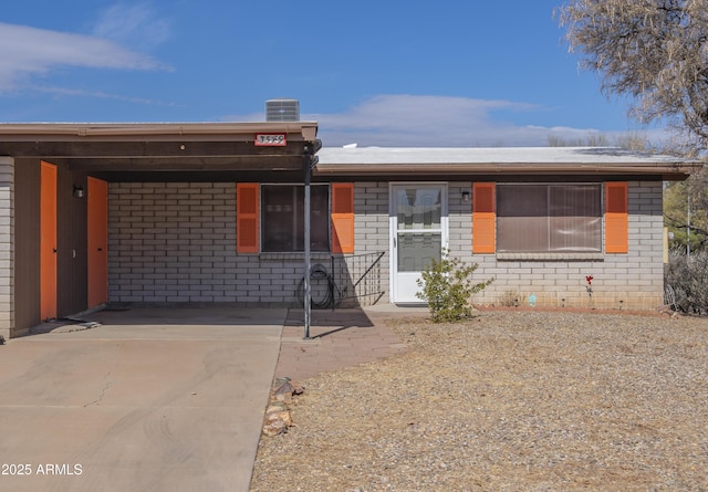 single story home with a carport and central air condition unit