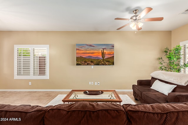 living room featuring light tile patterned floors and ceiling fan