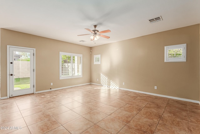 unfurnished room featuring light tile patterned floors and ceiling fan