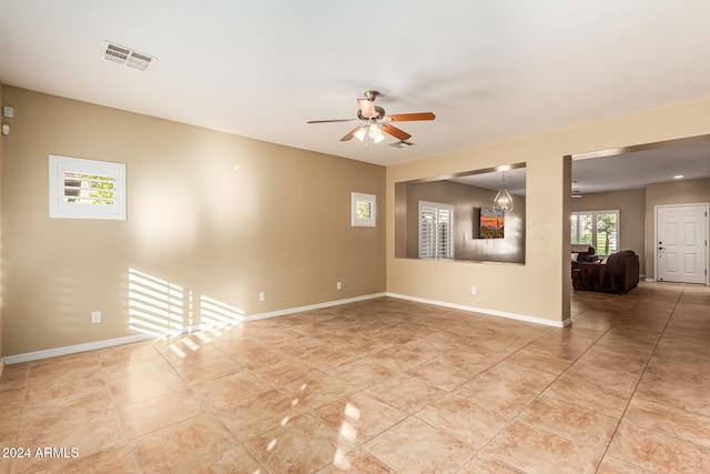 tiled empty room with ceiling fan