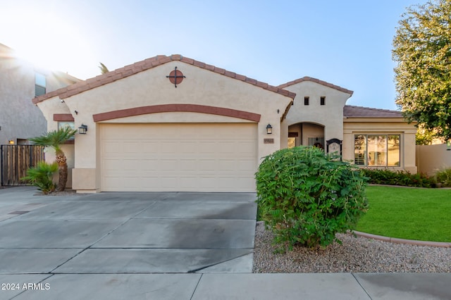 mediterranean / spanish-style house with a front lawn and a garage