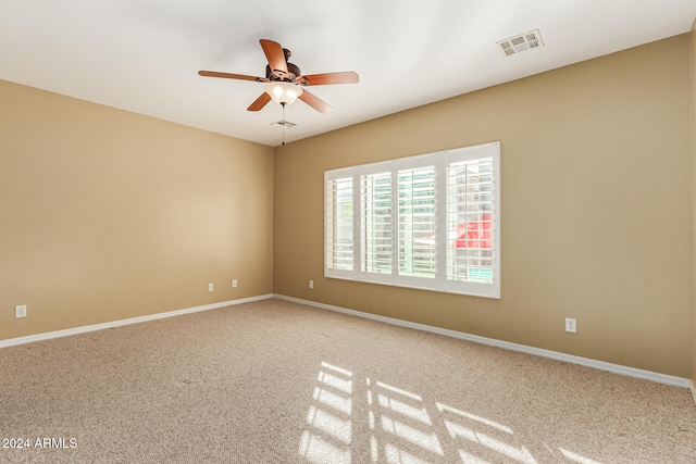 carpeted empty room featuring ceiling fan