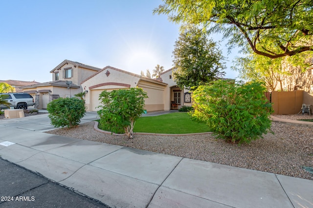 view of front of house with a garage and a front lawn