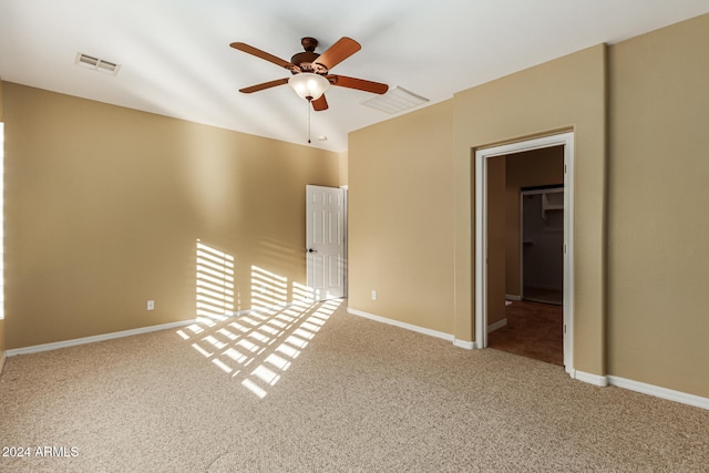 spare room featuring ceiling fan and carpet flooring