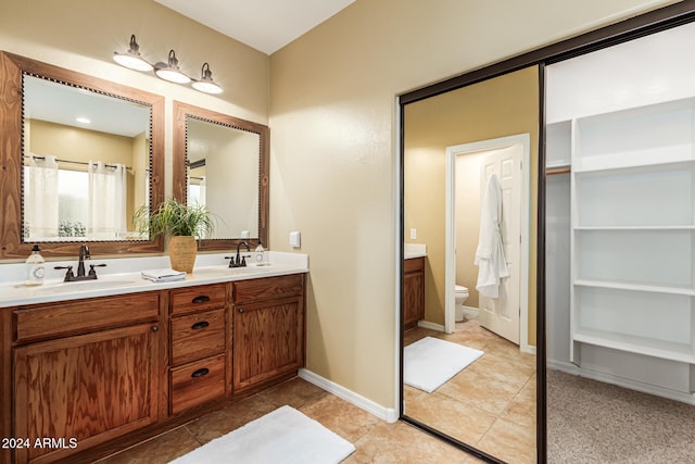 bathroom featuring tile patterned floors, vanity, and toilet