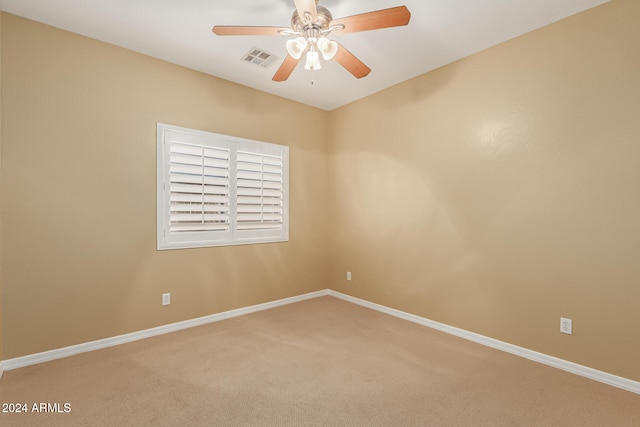 empty room with ceiling fan and carpet floors