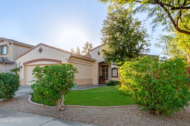 view of front of property with a garage and a front yard